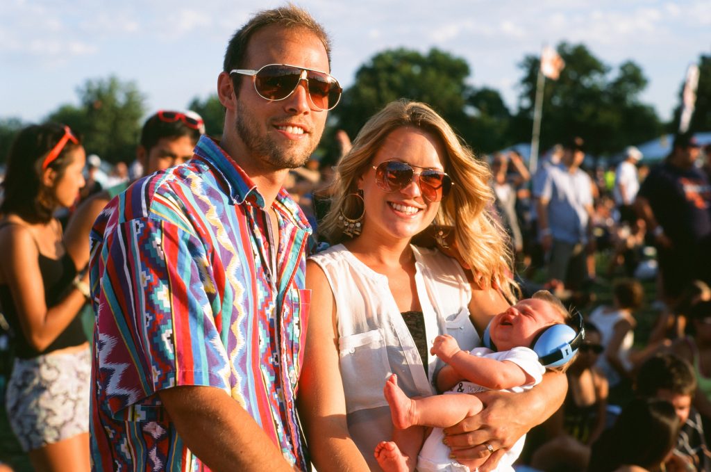 Picture of a couple at a music festival with a baby